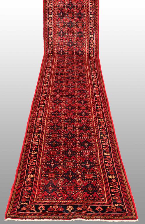 A Hosseinabad runner, c. 605 x 84 cm.