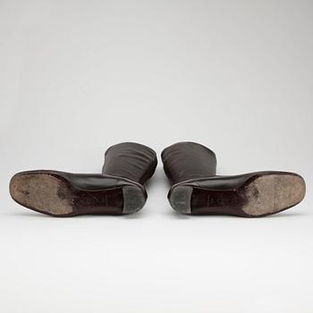 CHANEL a pair of brown leather boots.