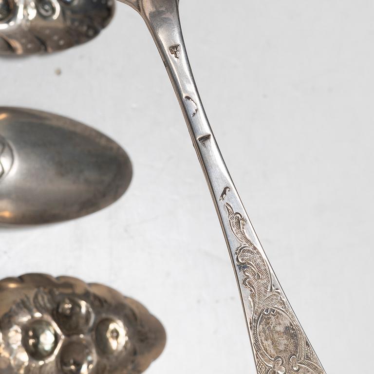 Seven silver spoons, including English and Swedish hallmarks.