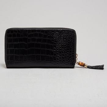 GUCCI, a leather wallet.
