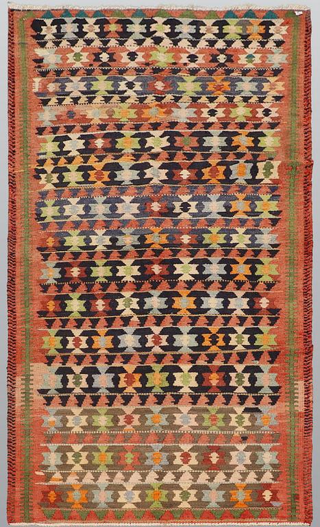 A carpet, Persian Nomad Kilim, ca 324 x 143 cm.