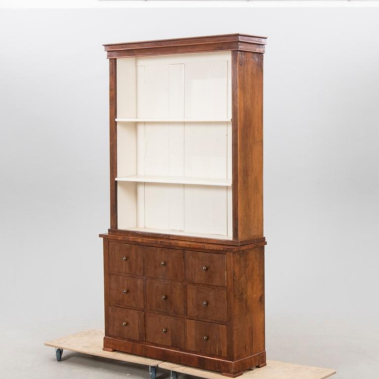 A stained walnut cabinet from the first half of the 20th century.