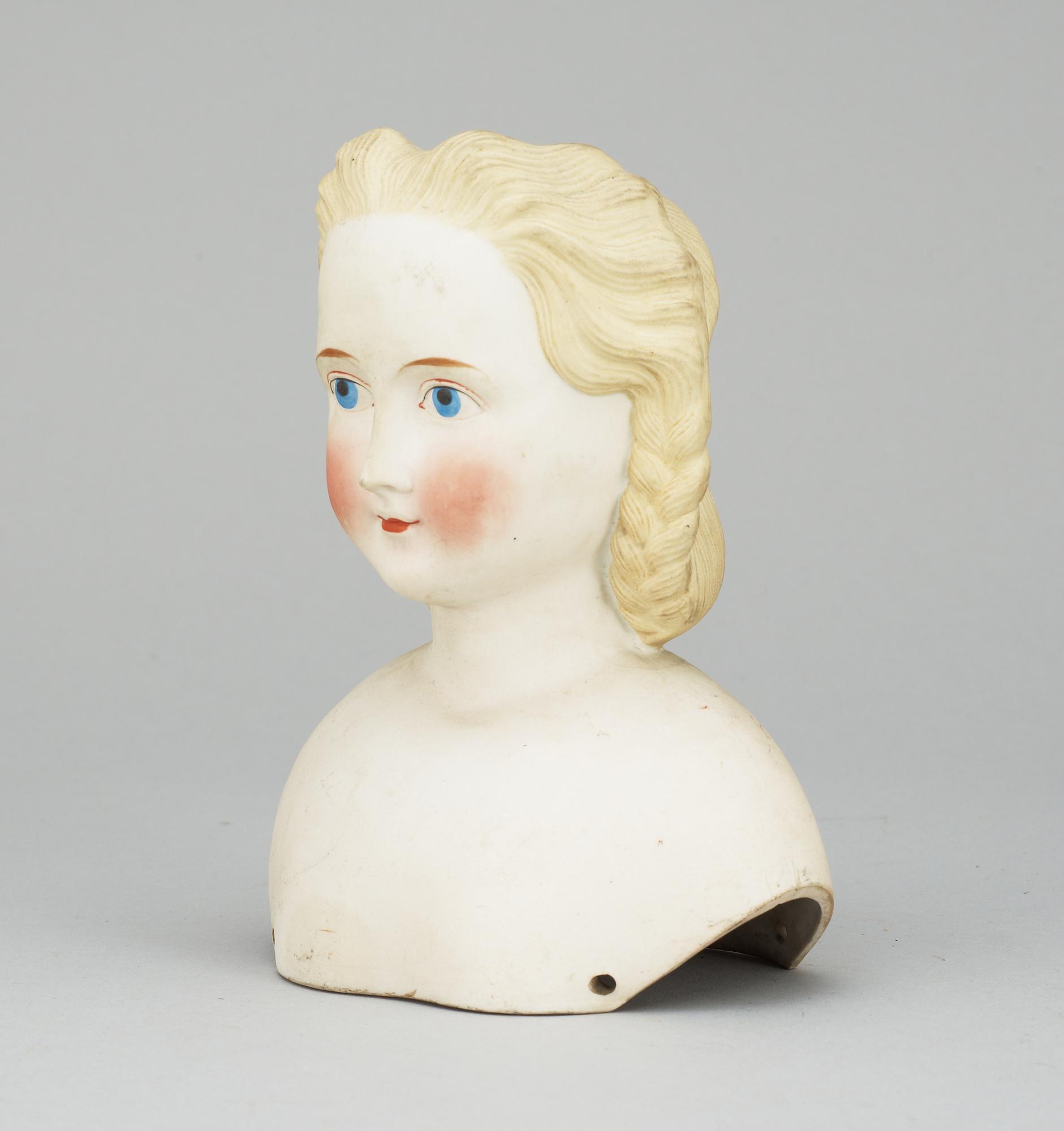 A 1860s-70s doll head, probably Germany.