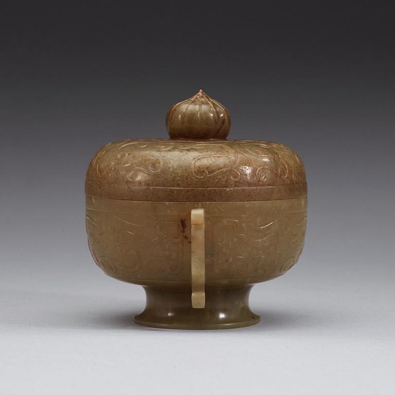 A carved archaistic nephrite bowl with cover decorated with taotie-masks, China, 20th Century.