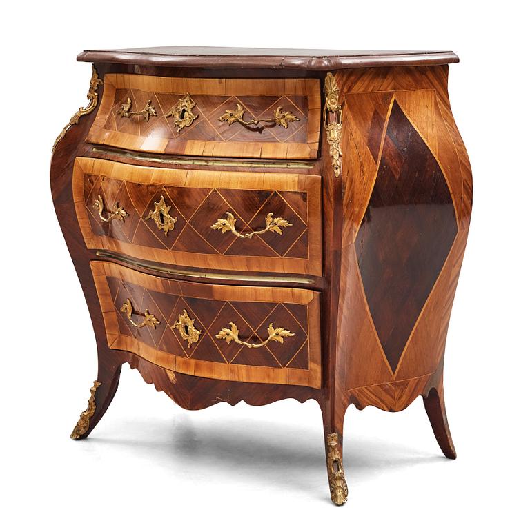 A Swedish rosewood-veneered Rococo chest of drawers, later part of the 18th century.