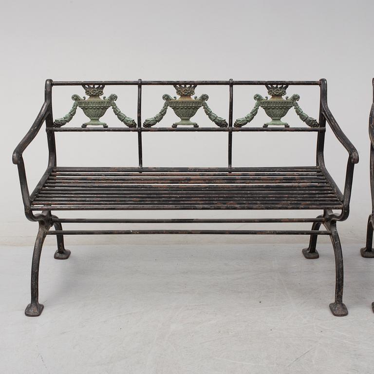 GARDEN SOFAS, a pair, cast iron, empire style, late 19th century.