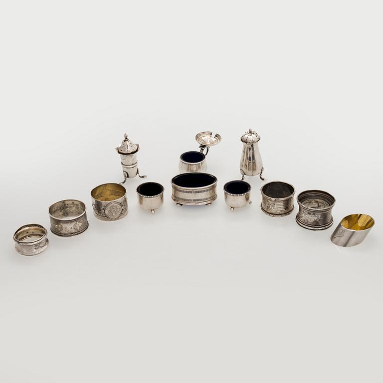 Napkin rings, 6 pcs, a pair of salt shakers, and salt cellars, silver and glass, including English and Finnish marks.