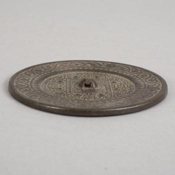 A bronze mirror, Xin-Eastern Han dynasty (9-220).