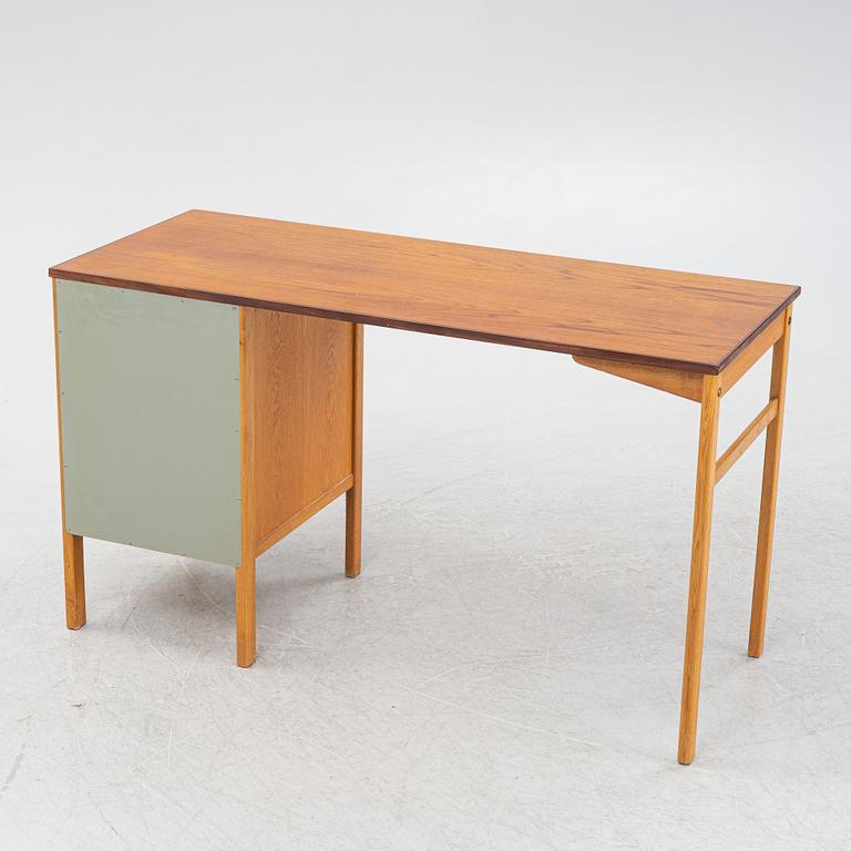 A teak veneered writing desk, 1960s.