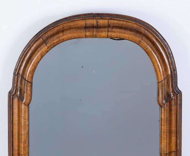 A late Baroque walnut-veneered mirror, first part of the 18th century.