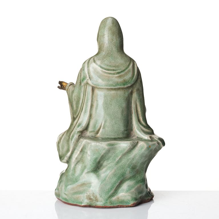 A seated celadon figure of Guanyin, presumably Longquan Ming dynasty, 17th Century.