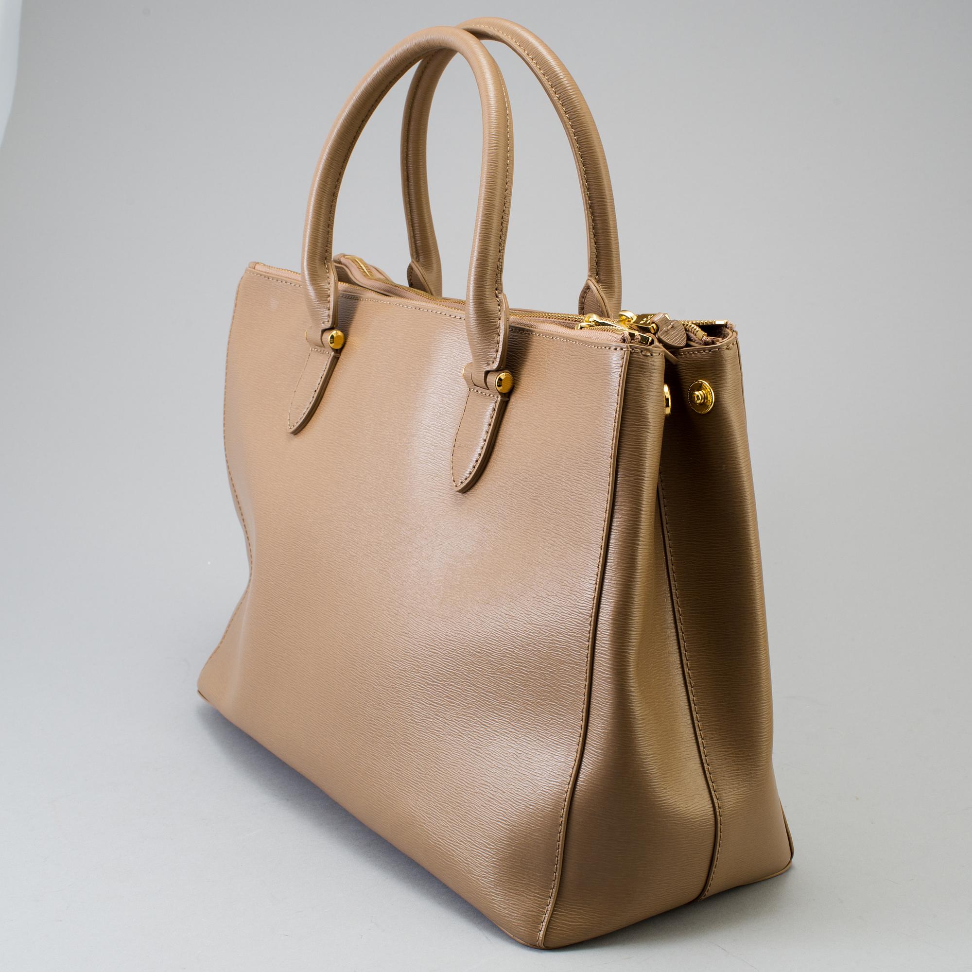 a "Newbury Double-Zip Satchel" bag by Ralph Lauren.