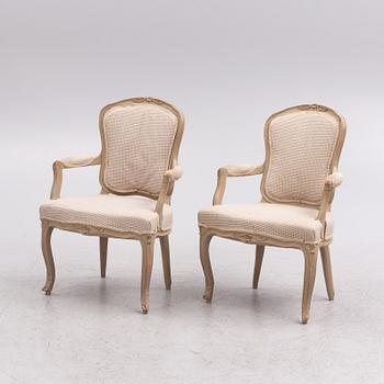 A painted pair of rococo armchairs, 19th century.