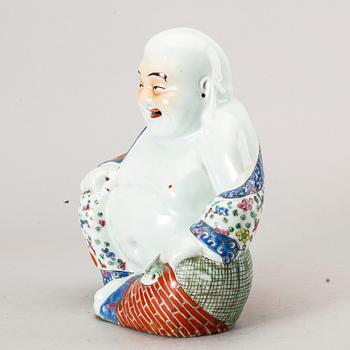 A Chinese porcelain buddha, 20th century.