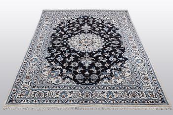 A rug, Nain, part silk, ca 242 x 167 cm.