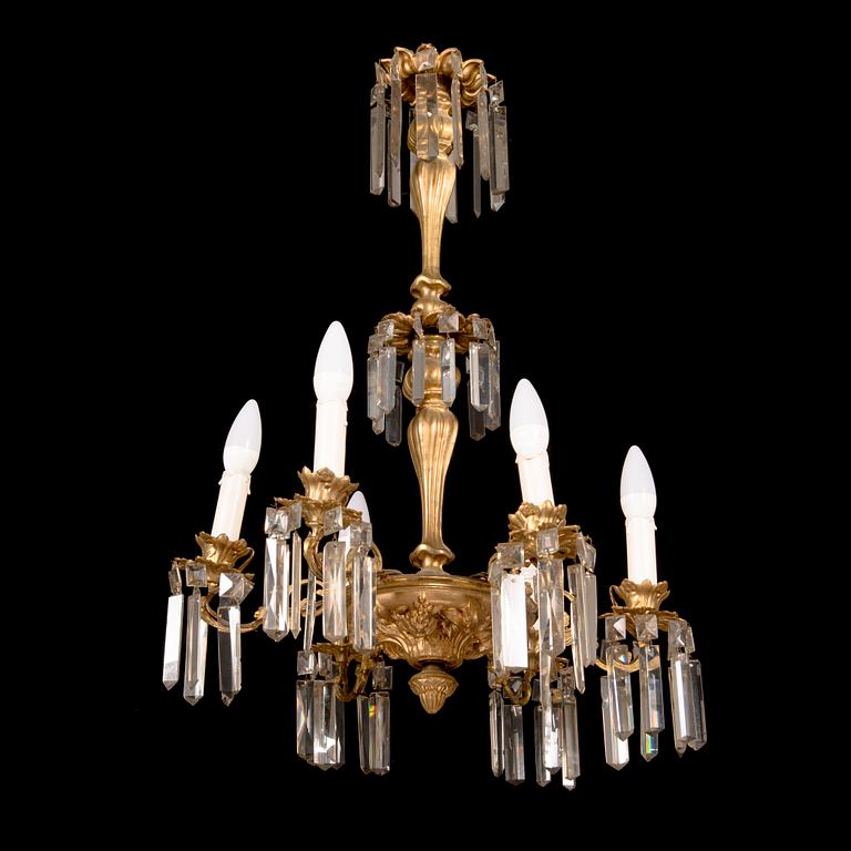 A brass chandelier with prisms, late 19th century. Height 75 cm.