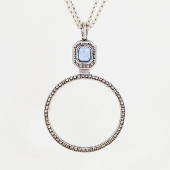 A platinum lorgnette set with a faceted sapphire and rose-cut diamonds.