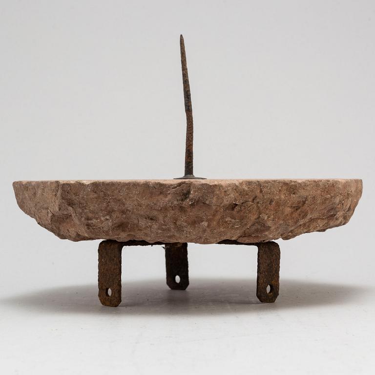 A limestone and iron sundial dated 1732.