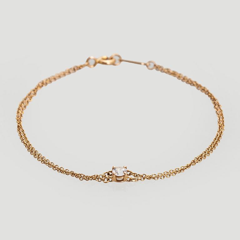 Tiffany & Co, armband, 18K guld med en briljantslipad diamant.