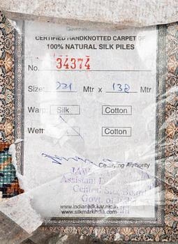 A Kashmir silk carpet. Circa 221 x 136 cm.