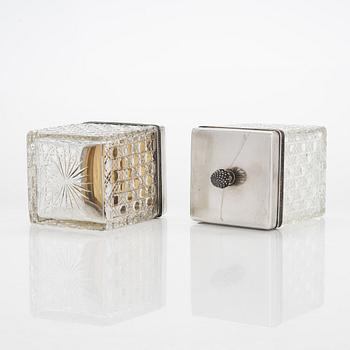 K. Fabergé, a pair of cut-glass toilette boxes in silver stand, Imperial Warrant mark, Moscow 1896.