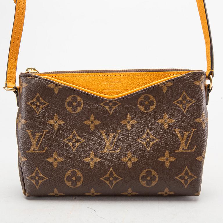 A Louis Vuitton Pallas clutch.