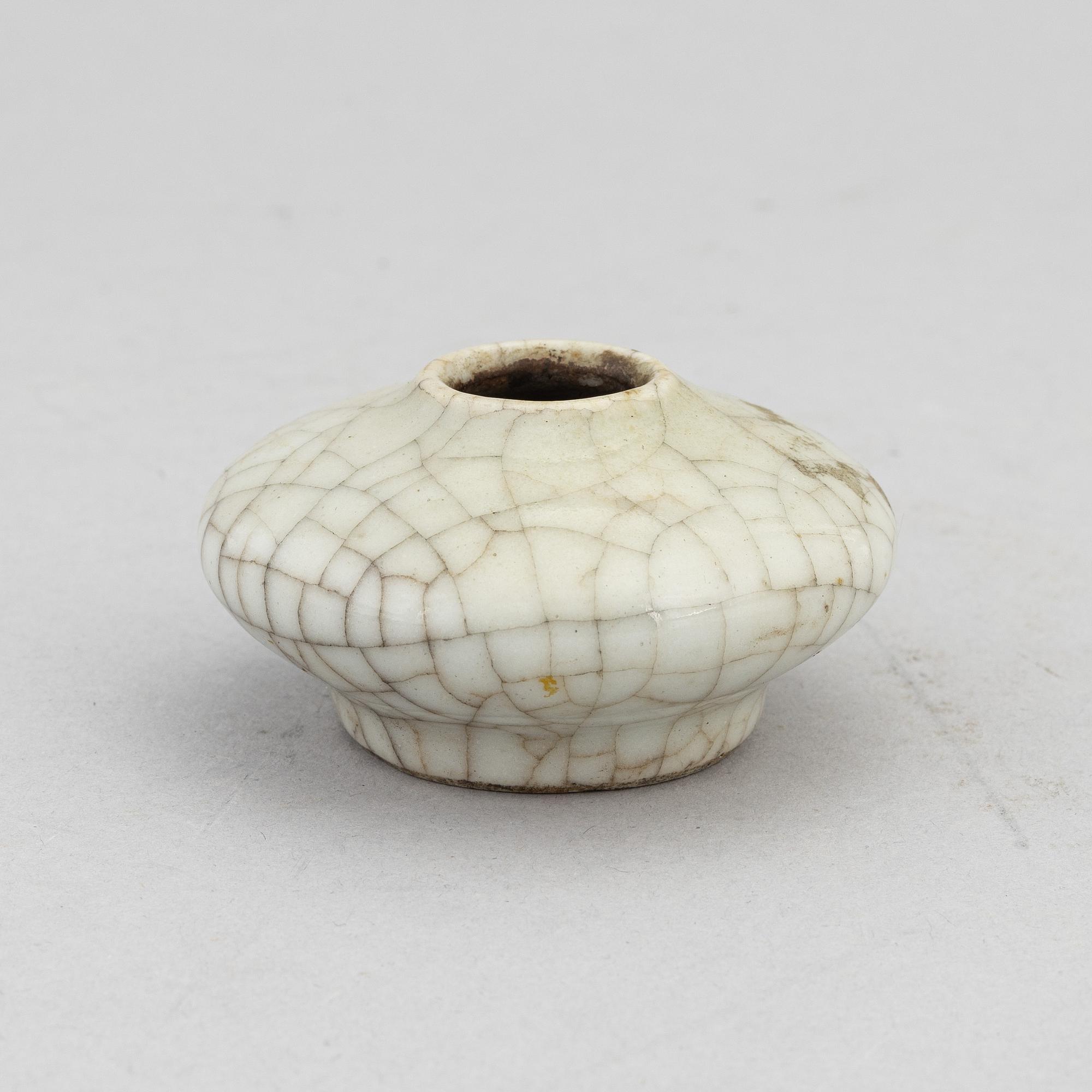 A Chinese celadon glazed lotus leaf shaped bowl, late Qing dynasty, and a ge-glazed brush washer, possibly 20 century.