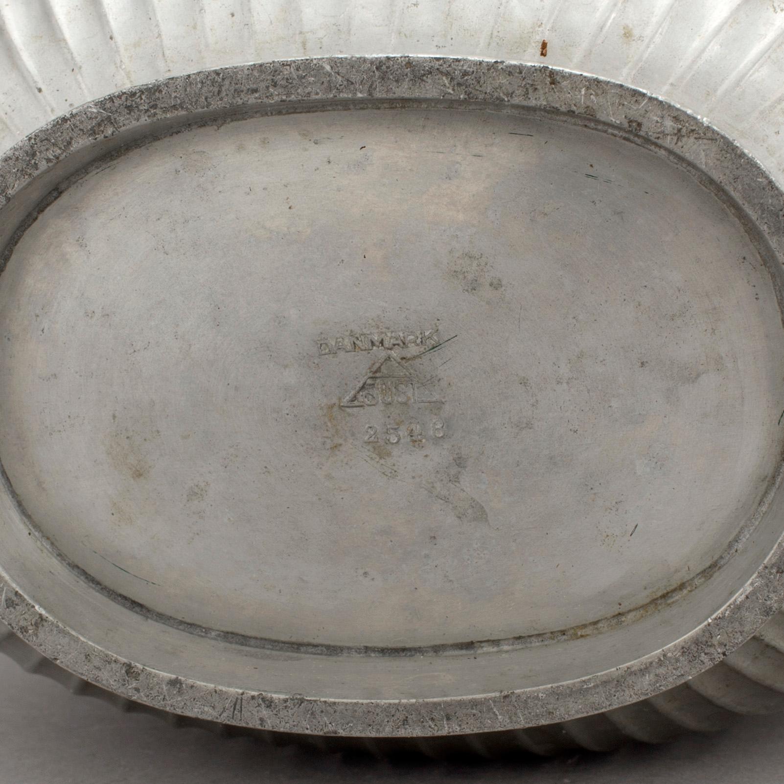 One pewter bowl and a pair of candleholders by Just Andersen, Denmark.