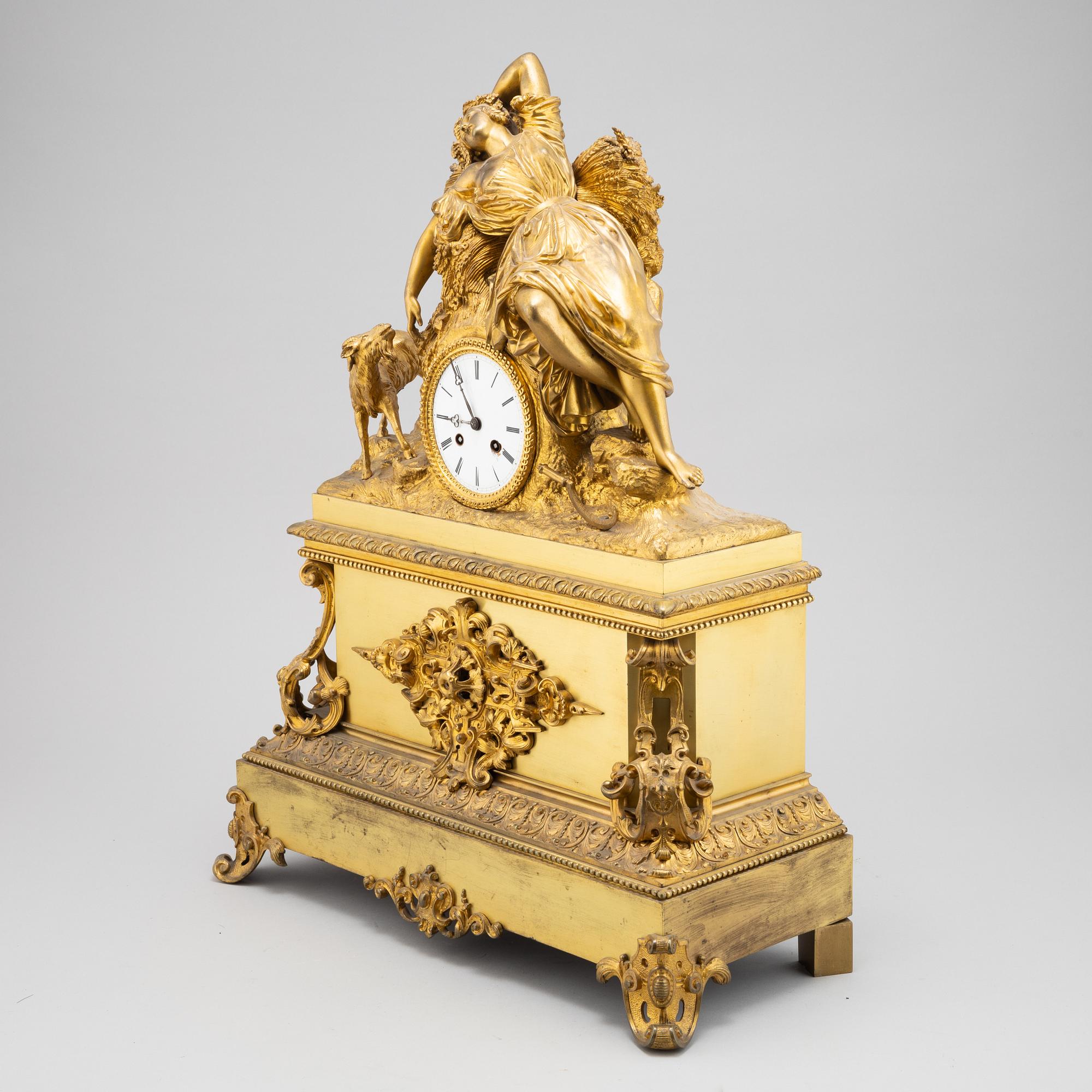 A mid 19th Century brass and gilt brass mantel clock.