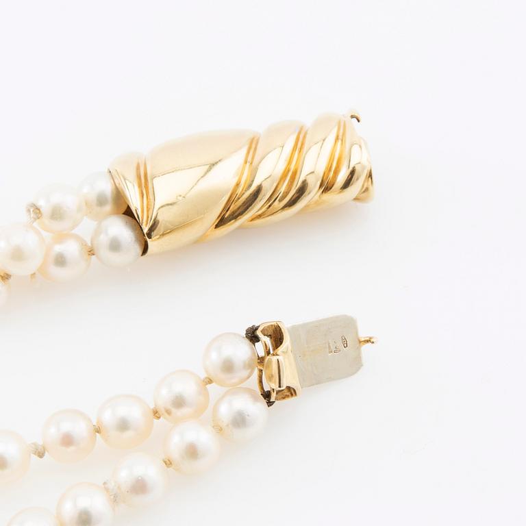 Necklace, two-stranded of cultured pearls with a clasp of 18K gold set with brilliant-cut diamonds, Damini Asolo Italy.