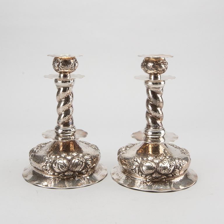 A pair of silver baroquestyle candlesticks. W.H.H, Stockholm. 1935. Filled foot.