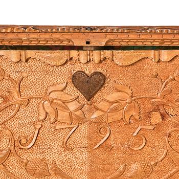 A baroque wedding casket, carved wood, dated 1725.