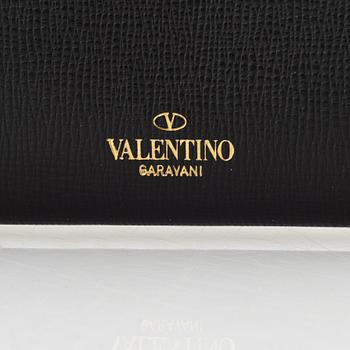 Valentino Garavani, a leather and studs wallet.