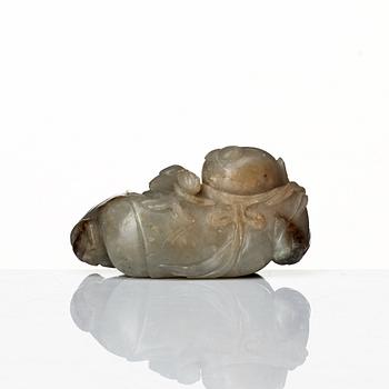 A neprite sculpture of a reclining boy with a duck, late Qing dynasty.