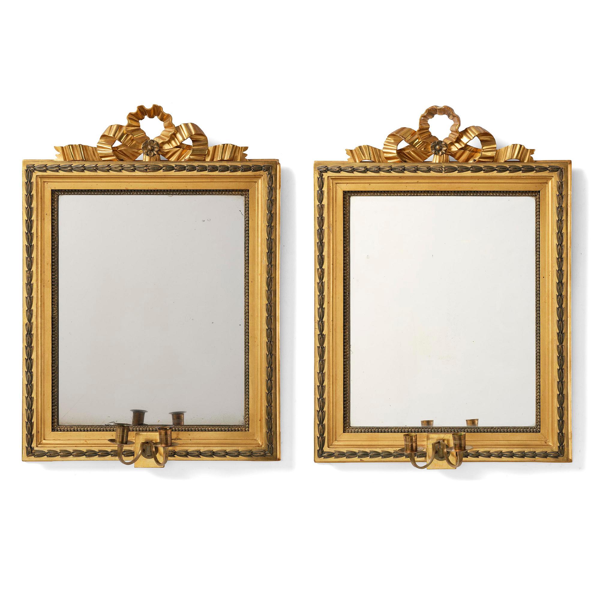 A pair of two-branch giltwood girandole mirrors attributed to P. Ljung (1743-1819).