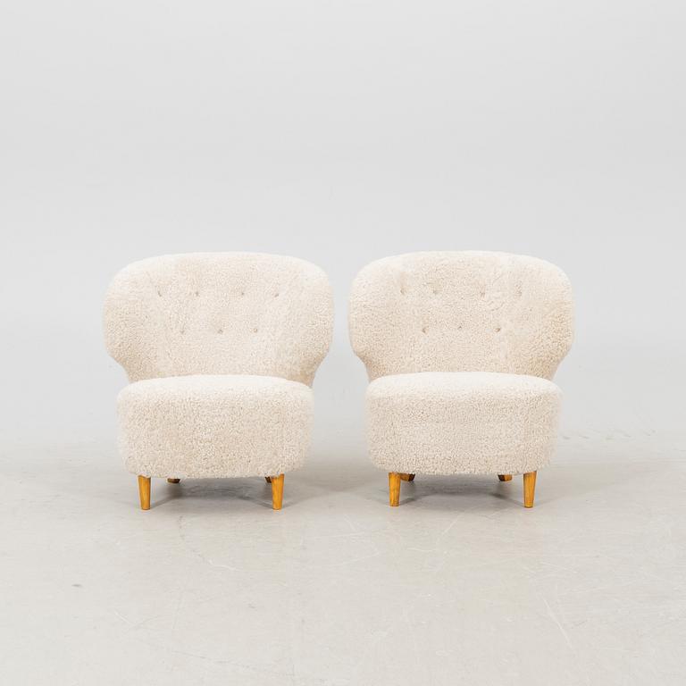 A pair of Scandinavian Modern 1940s cheepskin armchairs.