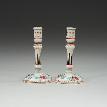 A pair of famille rose candle sticks, Qing dynasty, Qianlong (1736-95).