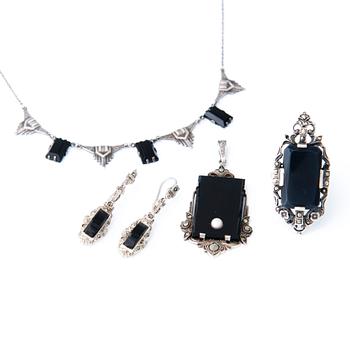 Four Art deco jewelry, ring, pendant necklace and earrings in silver.