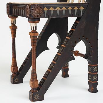 CARLO BUGATTI, an ebonized wood and walnut chair, Turin, Italy ca 1900.