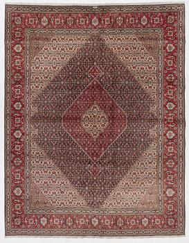A signed Tabriz carpet, c. 385 x 300 cm.