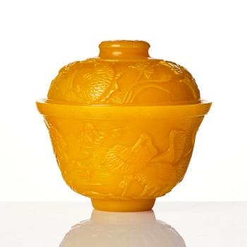 A well carved yellow glass 'crane and lotus' cup with cover, presumably late Qing dynasty.
