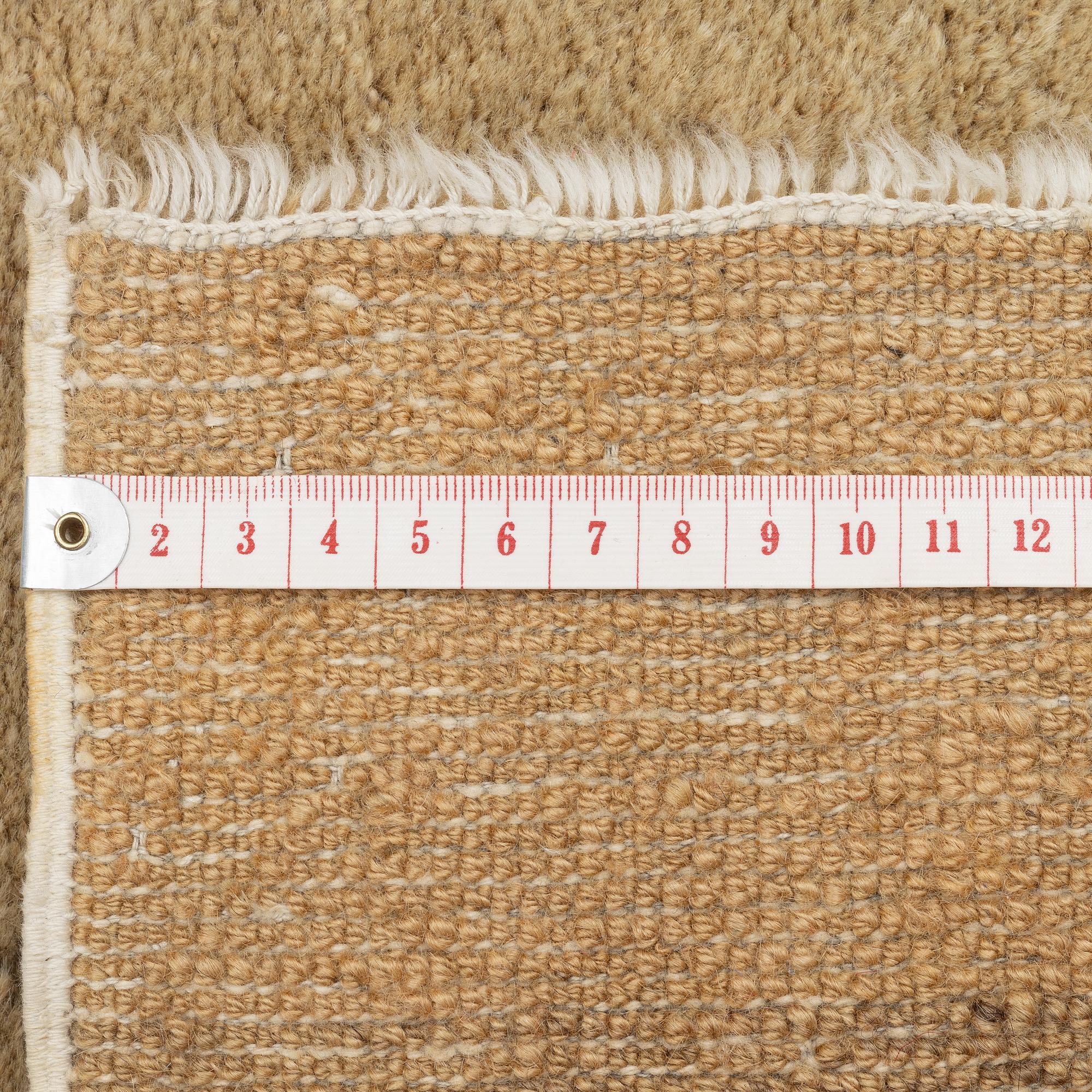 An antique Baotou rug, China, c. 127 x 66 cm.