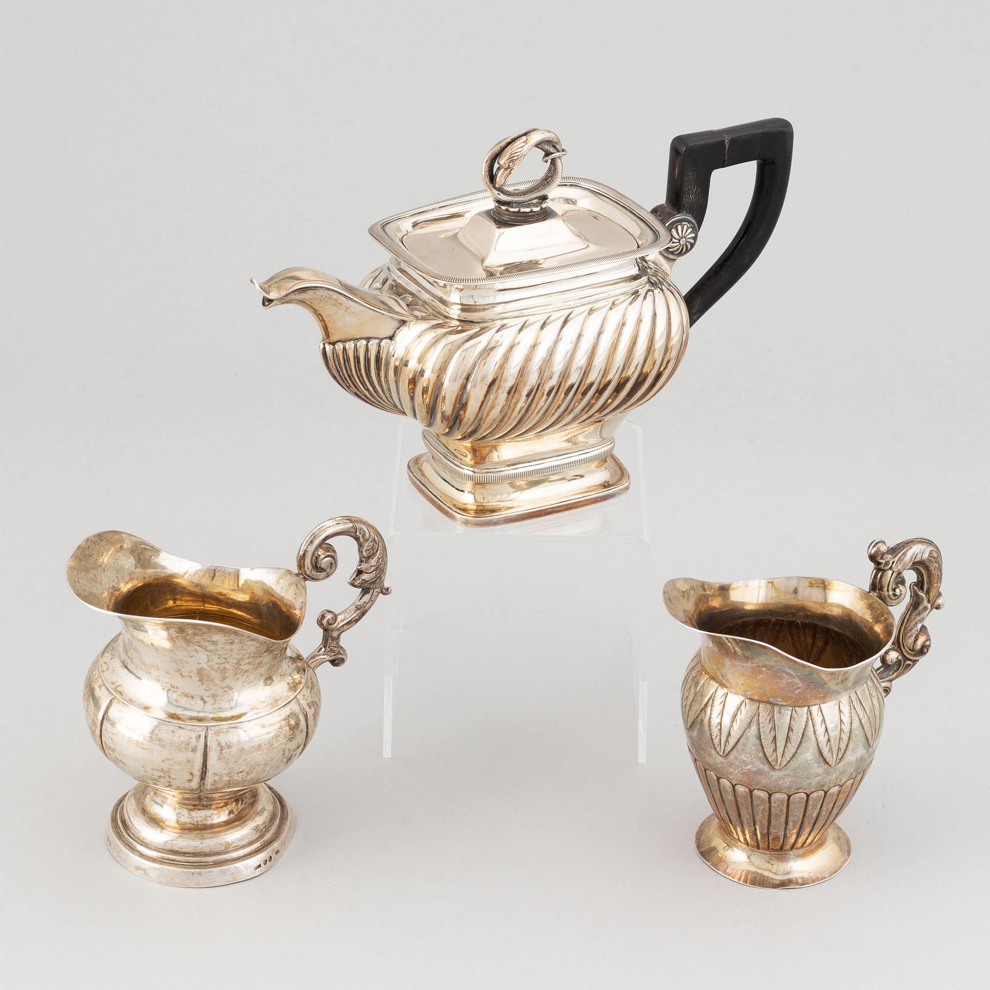 A mixed lot of two 19th century silver and parcel-gilt creamers and a coffee-pot.