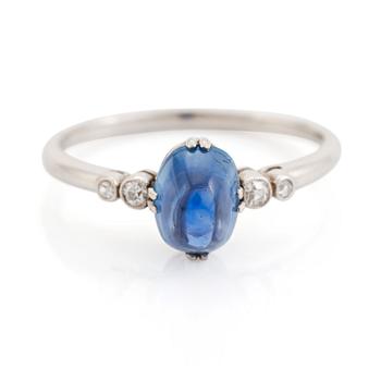 408. A platinum ring set with a cabochon-cut sapphire.