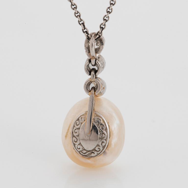 A platinum and pearl pendant set with old-cut diamonds.