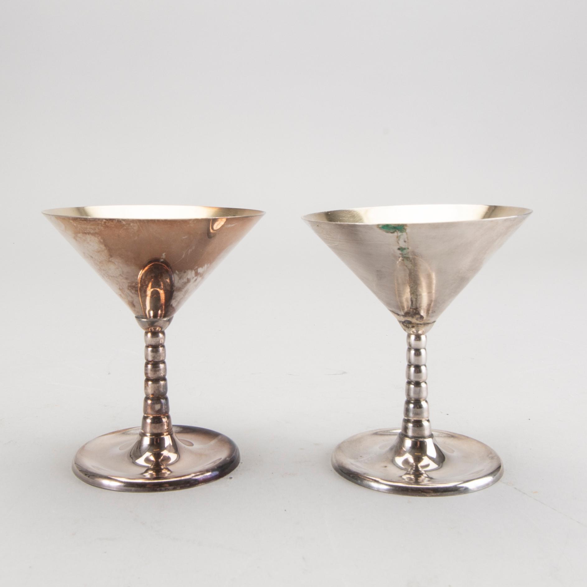 A set of 12 silver plated cocktail glasses and a shaker mark By CG Hallberg Stockholm mid 1900s.