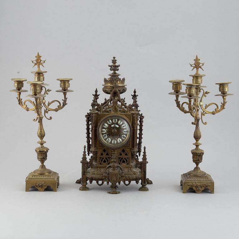 A mantle clock with pair of candelabra, late 19th century.