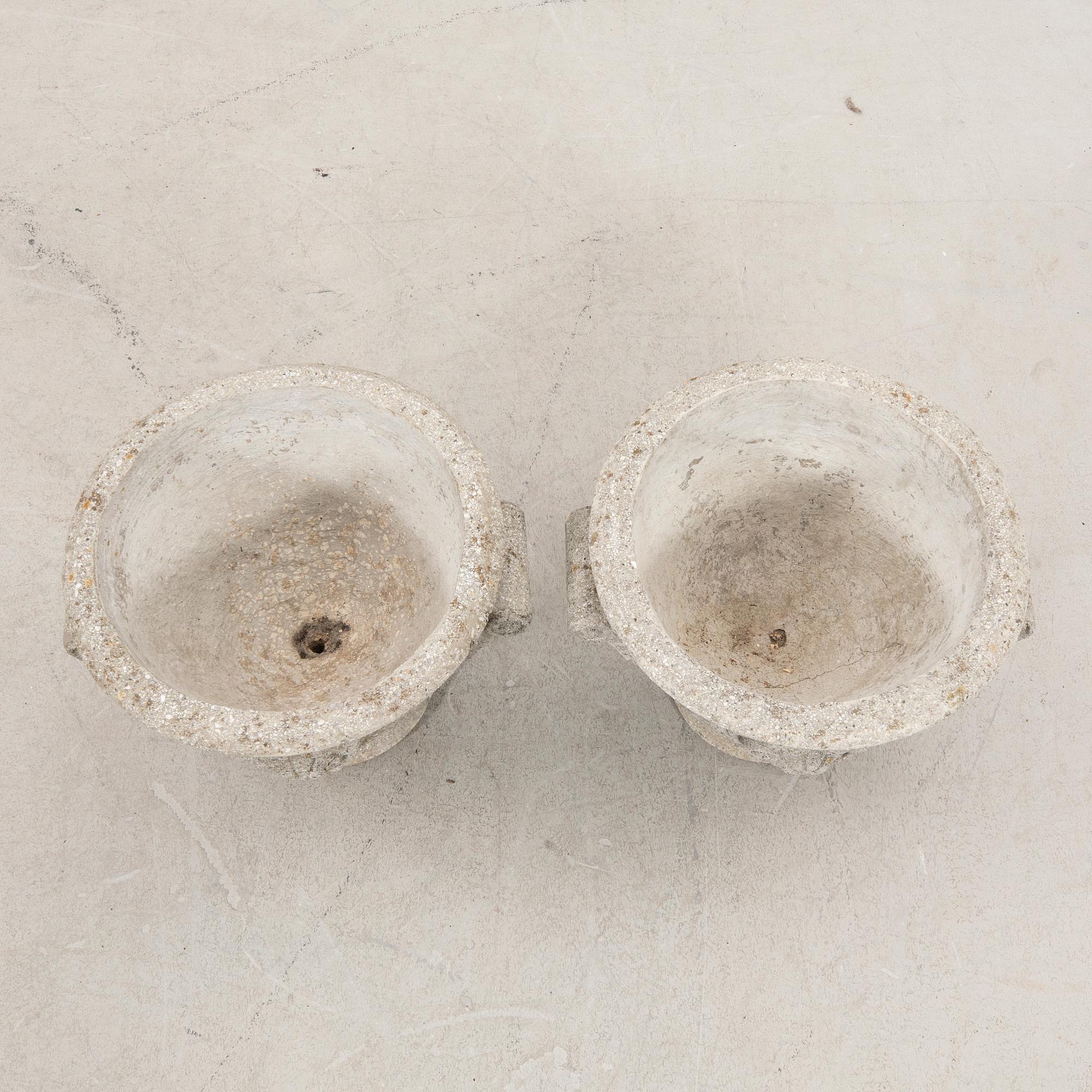 A pair of concrete garden urns 20th century.