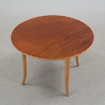 A mid 20th century coffee table in beech and veneered with mahogany.