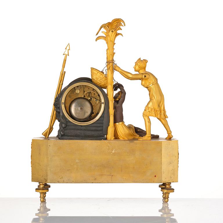 A figural Empire ormolu and patinated bronze mantel clock, early 19th century.